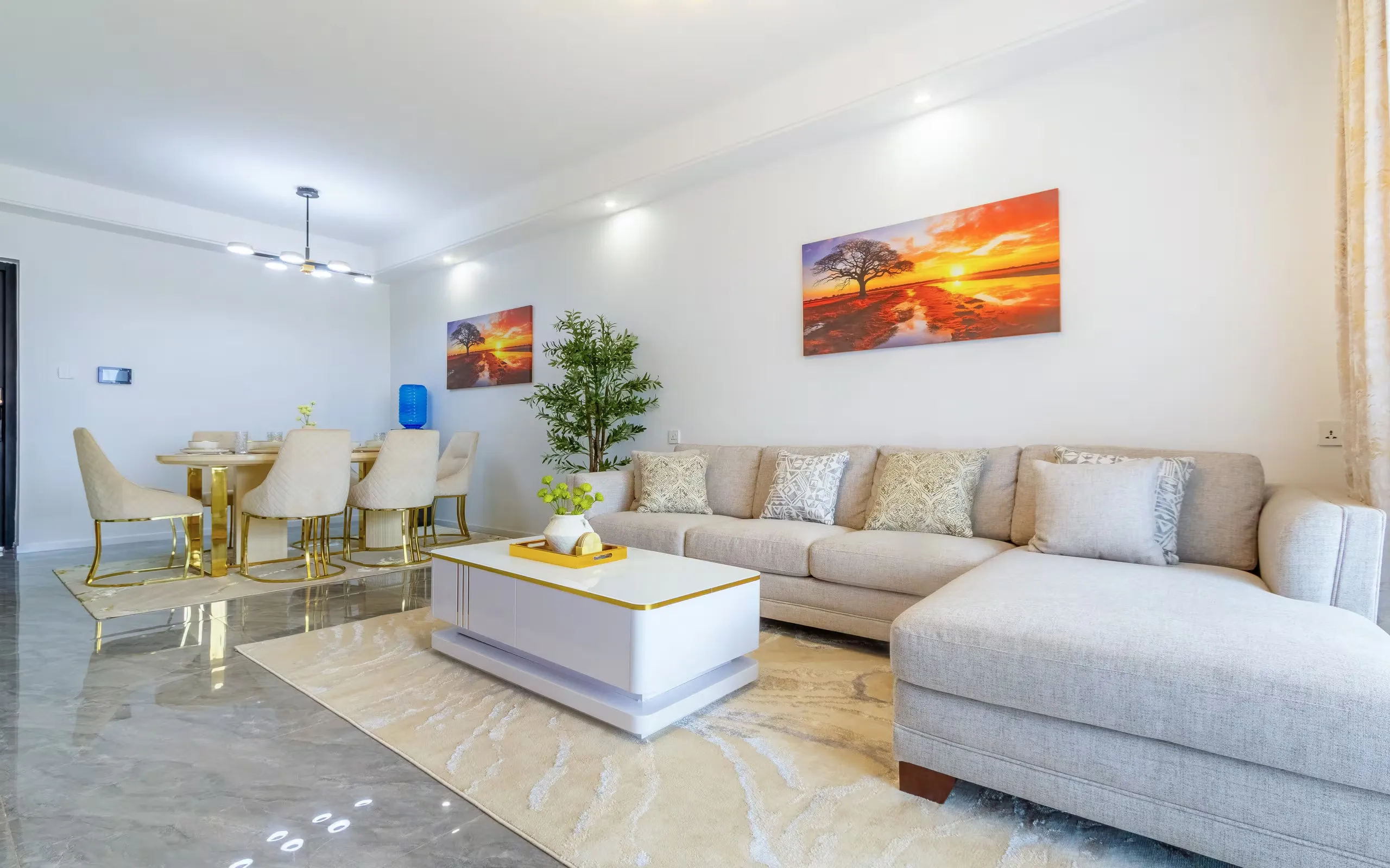 Grey sectional sofa with patterned cushions in a bright living room